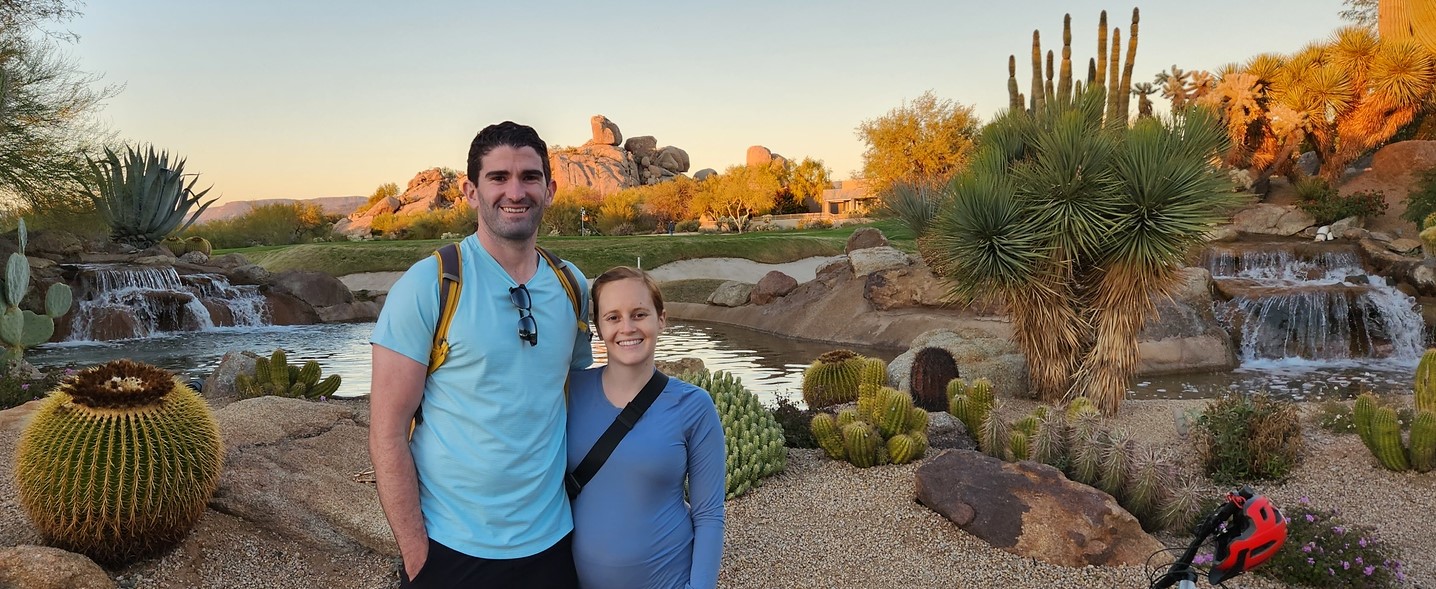 A couple on one of the Phoenix mountain bike tours from the Wild Bunch poses for a picture at a gorgeous Sonoran Desert oasis.