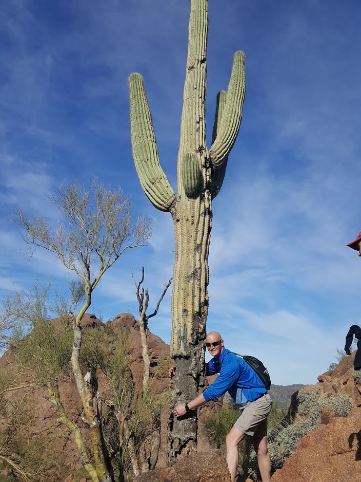 A Wild Bunch guest gives a Saguaro Cactus a hug.