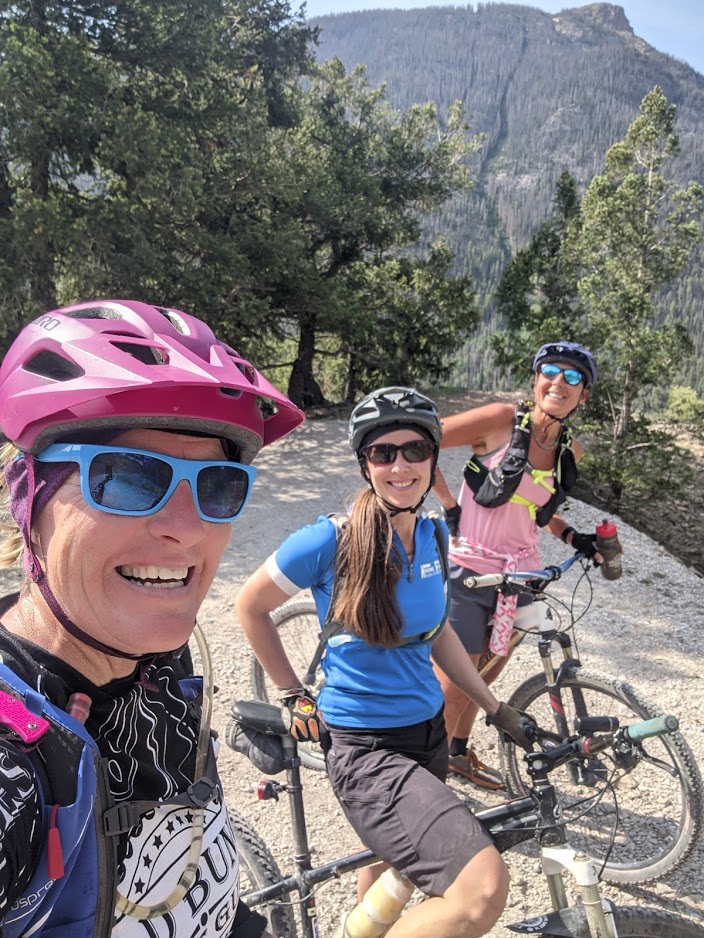 Laurel Darren (left) pauses to enjoy the incredible scenery and the amazing company of her mountain biking pals Lydia McNeese (center) and Amanda Hartman (right) during a three-month summertime visit to Lake City, Colo. Darren is the owner of Arizona's Wild Bunch Desert Guides. McNeese and Hartman are both from Lake City and training with Darren for a mountain bike race there next month. 