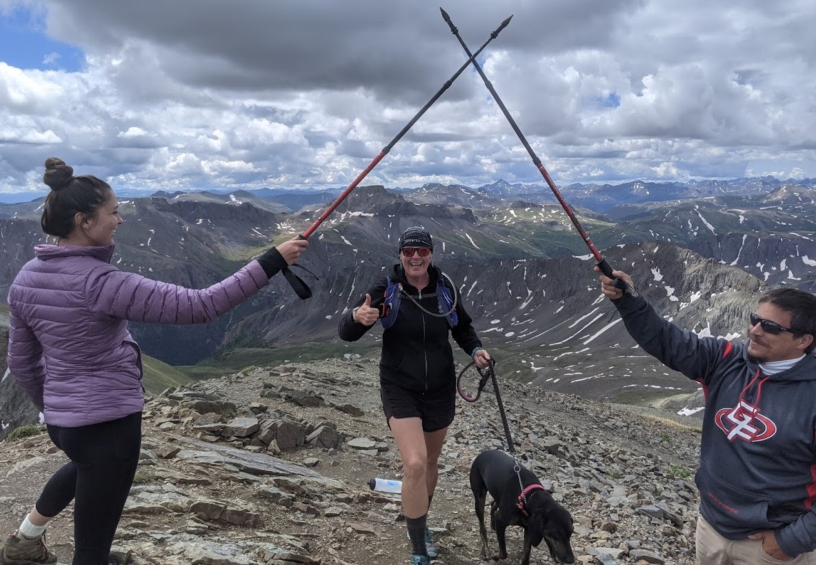 With hiking poles hoisted to the heavens, Laurel Darren (center), owner of Arizona's Wild Bunch Desert Guides, is 