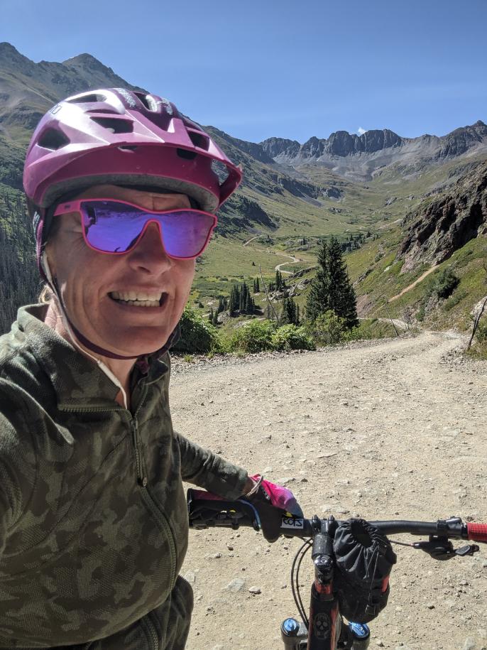 Laurel Darren -- owner of Wild Bunch Desert Guides, a highly-rated Phoenix adventure tours company -- pauses to share a big smile during a mountain bike ride in the Lake City region of Colorado's scenic San Juan Mountains. Darren spent the summer again in Lake City and the work break 