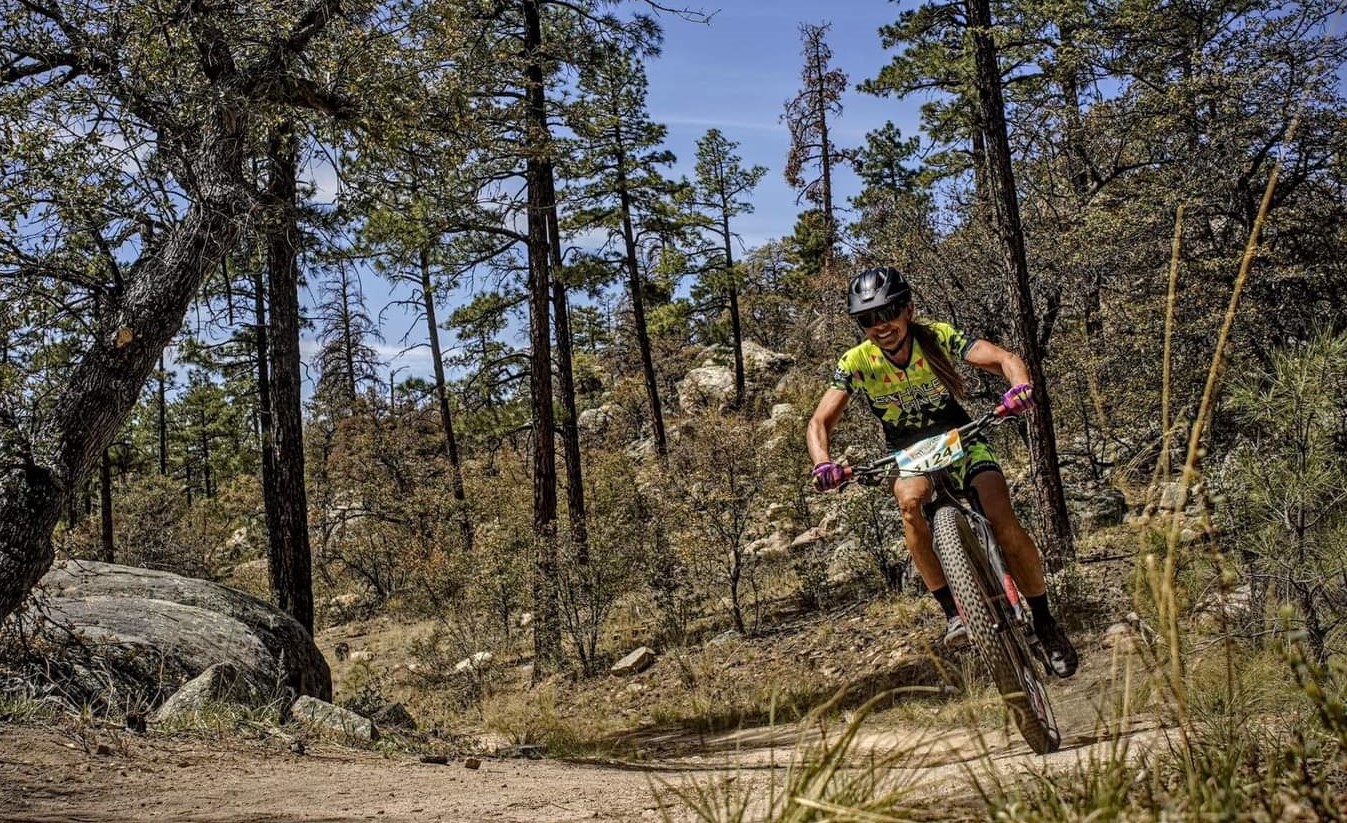 Ellen comes roaring down a hill during a mountain bike race.