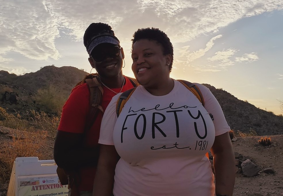 No matter the age, ADA accessible hiking trails in Phoenix allows every member of a family to experience the beauty and once-in-a-lifetime memories of a Phoenix hiking tour. Here with the sun poking over the horizon, two women from the same family celebrate a 40th birthday party with the Wild Bunch Desert Guides.