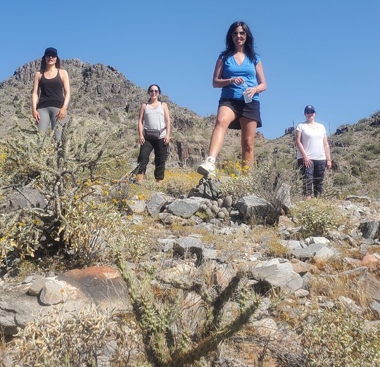 A group of friends pose for a memorable photo during a Phoenix hiking tour with the Wild Bunch Desert Guides.