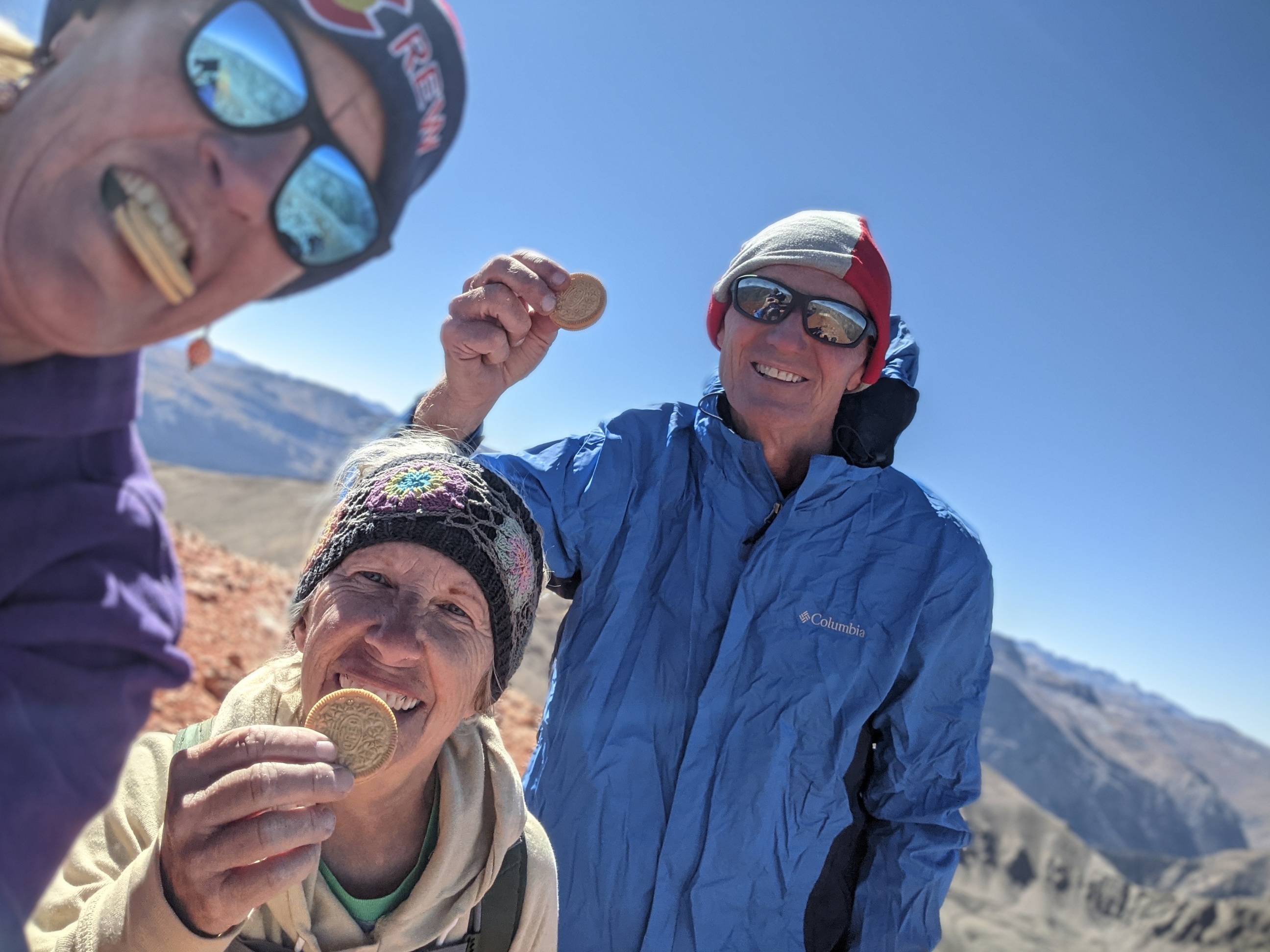 Laurel Darren (left), owner of the Wild Bunch Desert Guides, enjoys some Golden Oreos with Caron Jones (center) and Glenn Heumann (right) of the Lake City Hiking Club. The trio were celebrating reaching the summit of the 14,000-foot Redcloud peak during a hike in late Sept. 2021.