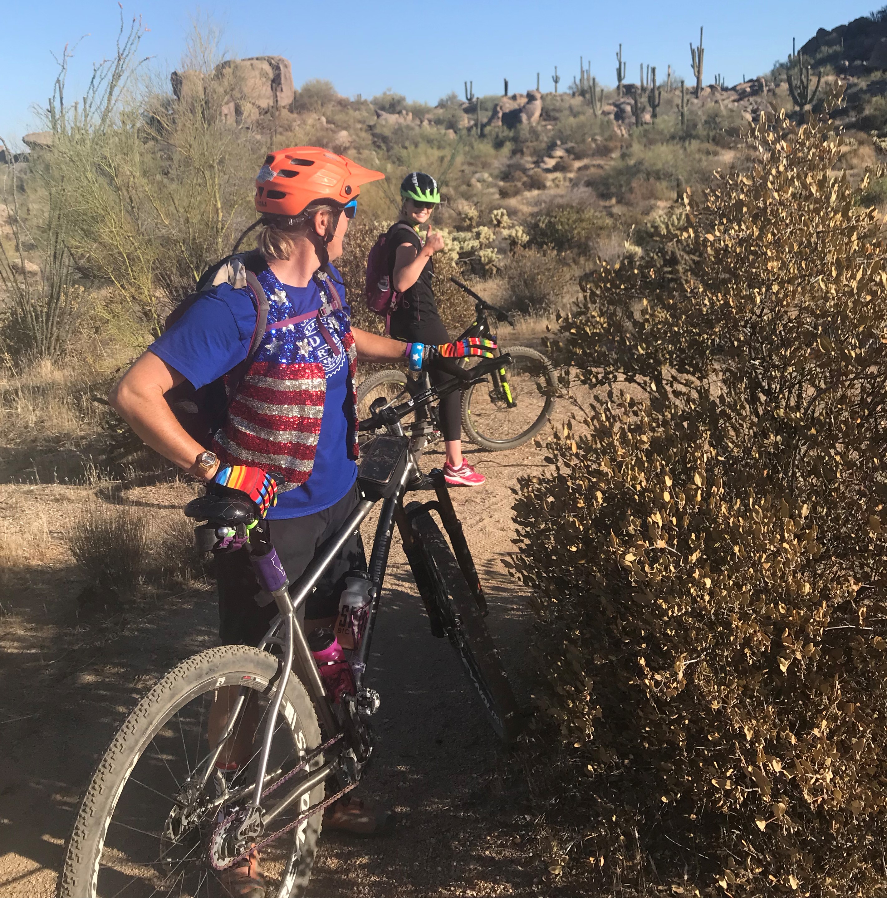 Wild Bunch Desert Guides owner Laurel Darren (front) receives a thumb's up from Emma Thornton during a Heinly family Phoenix mountain bike tour in 2018.