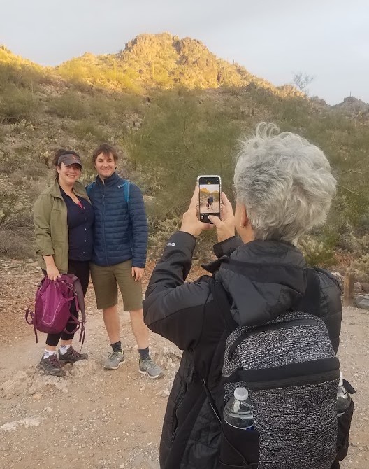 A group of three hikers pause in the early morning cool for a picture in the breathtaking Sonoran Desert scenery after experiencing an amazing Arizona sunrise during one of the Phoenix hiking tours offered by the Wild Bunch.