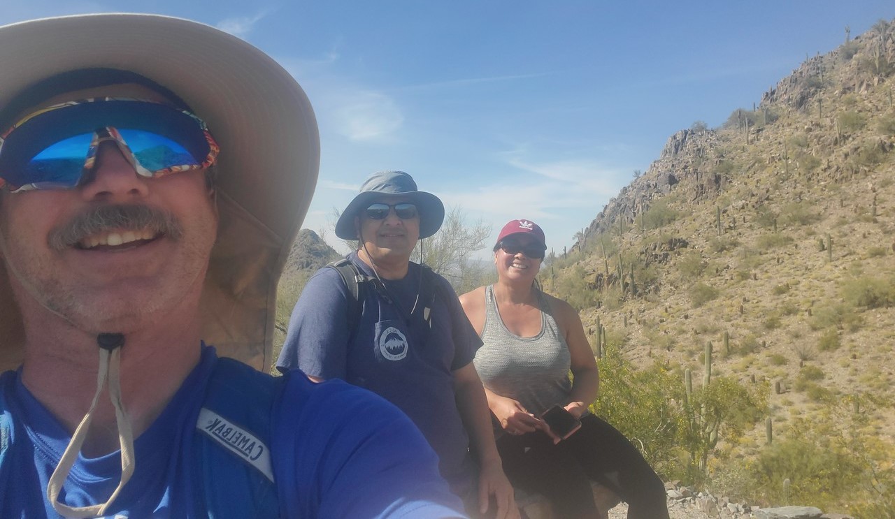 Hikers and their Wild Bunch guide take a quick break to admire the scenery on their Phoenix adventure tour.