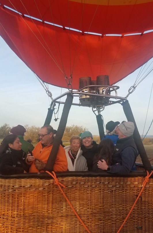 Wild Bunch owner Laurel Darren (smiling, center) is excited for lift-off at the start of her Hot Air Expeditions experience.