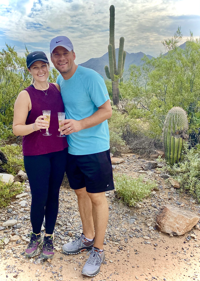 A couple celebrates an anniversary with a glass of Champagne during a Phoenix hiking tour with the Wild Bunch.
