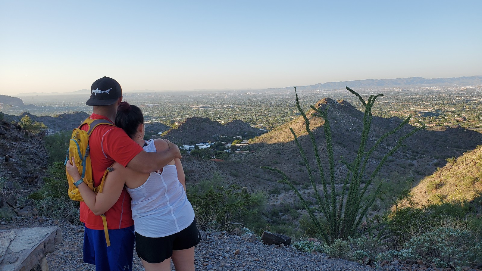 A couple embrace while taking in another beautiful view together during one of the Scottsdale hiking tours with Wild Bunch Desert Guides. 