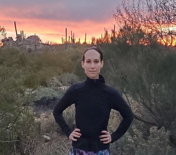 With a gorgeous sunset and southwestern landscape as the backdrop, a guest pauses during one of the Phoenix hiking tours with the Wild Bunch.