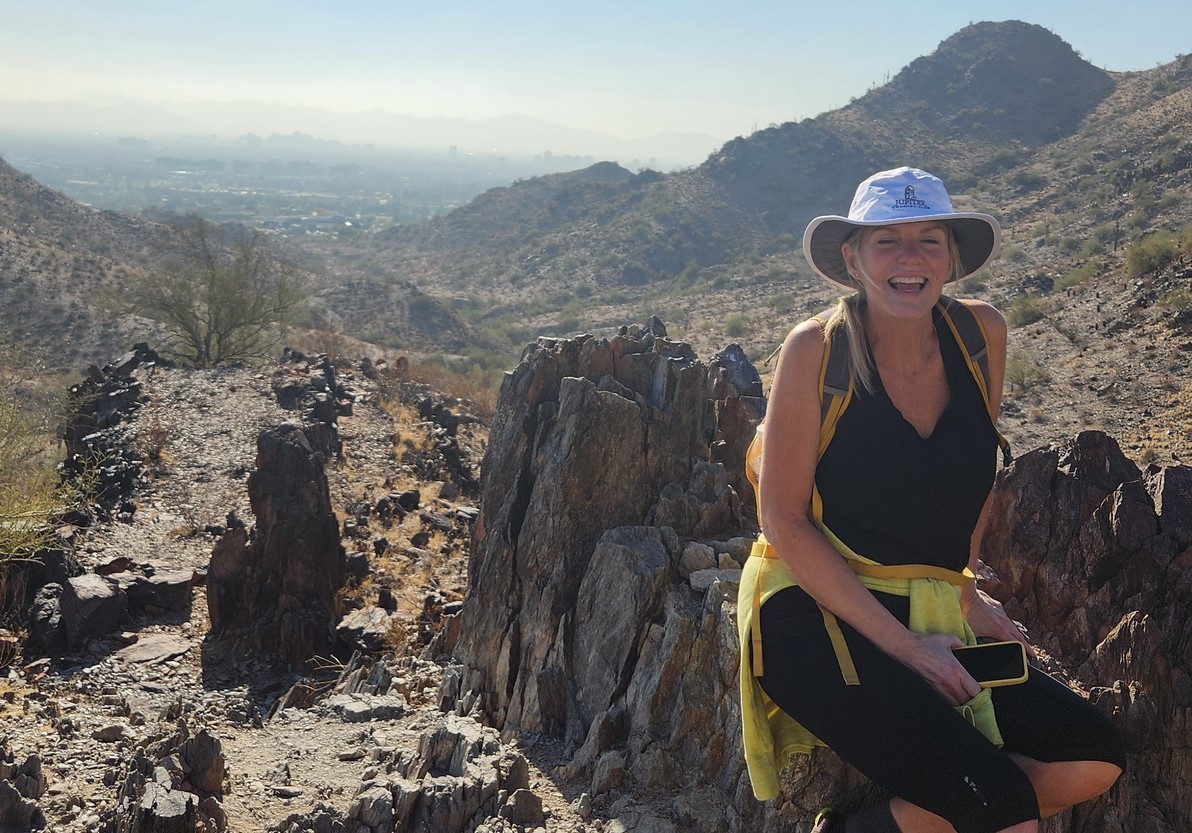 A female guest is all smiles during one of the Phoenix hiking tours from the Wild Bunch Desert Guides.