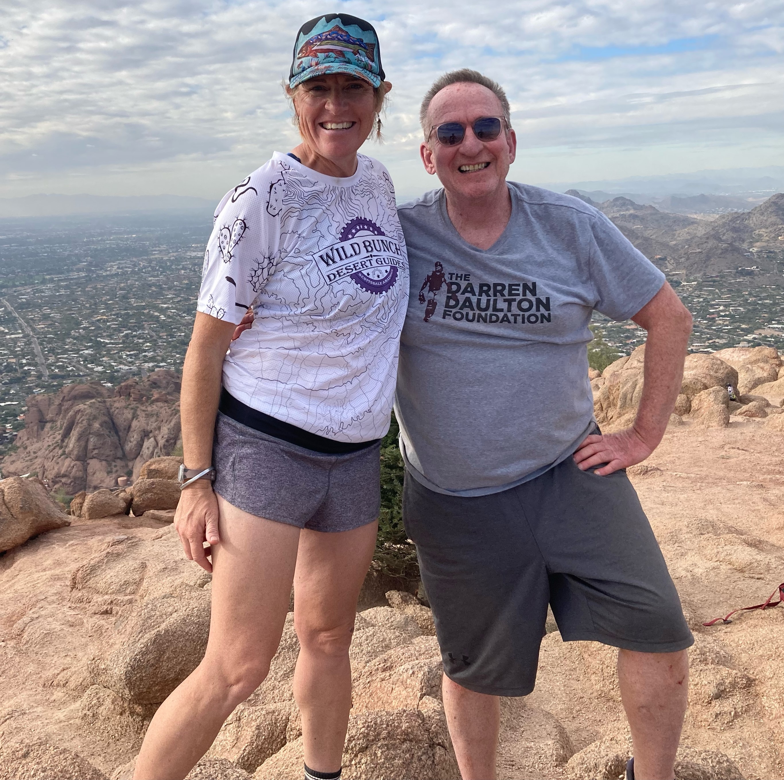 Laurel Darren (left) and John Duffin pause to pose together atop Camelback Mountain during one of the Wild Bunch Desert Guides epic Phoenix hiking tours on the iconic Arizona landmark.