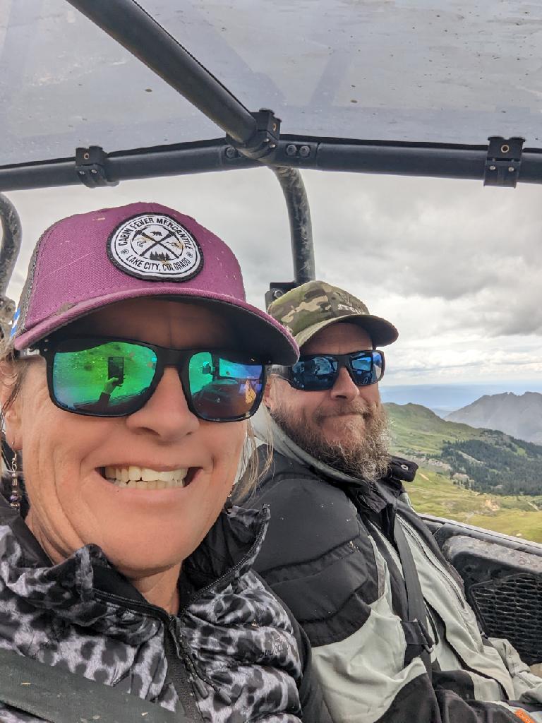 Wild Bunch Desert Guides owner/operator Laurel Darren (left) is all smiles seated next to her longtime boyfriend Brett during one of their many memorable experiences -- this one an off-road thrill-ride with Stellar Adventures, the company Brett works with.