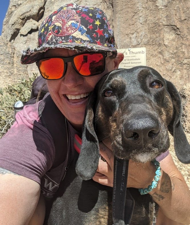 Wild Bunch Desert Guides owner Laurel Darren takes a break from hiking in Phoenix to pose for this picture with her all-time favorite companion for a hike, her Plot Hound, Daisy Mae.