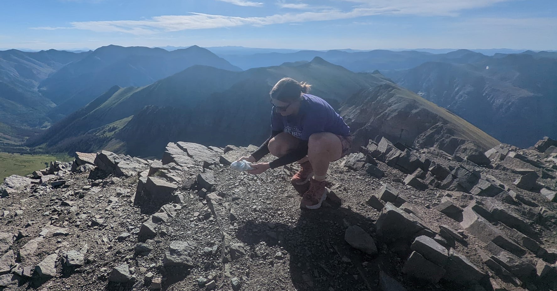 Laurel Darren spreads some of the ashes of her beloved Daisy Mae on the summit of Handies Peak in the Lake City region of Colorado's San Juan Mountains.