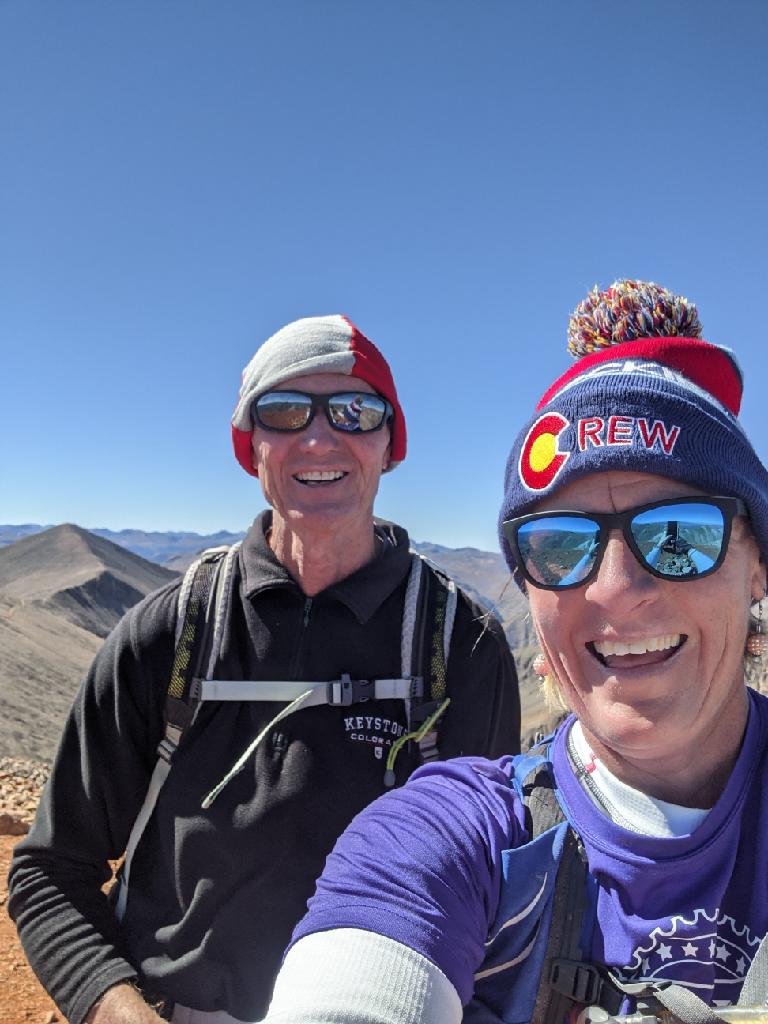 Laurel Darren (right) poses on a mountain top with Glenn Heumann of the Lake City Hiking Club.