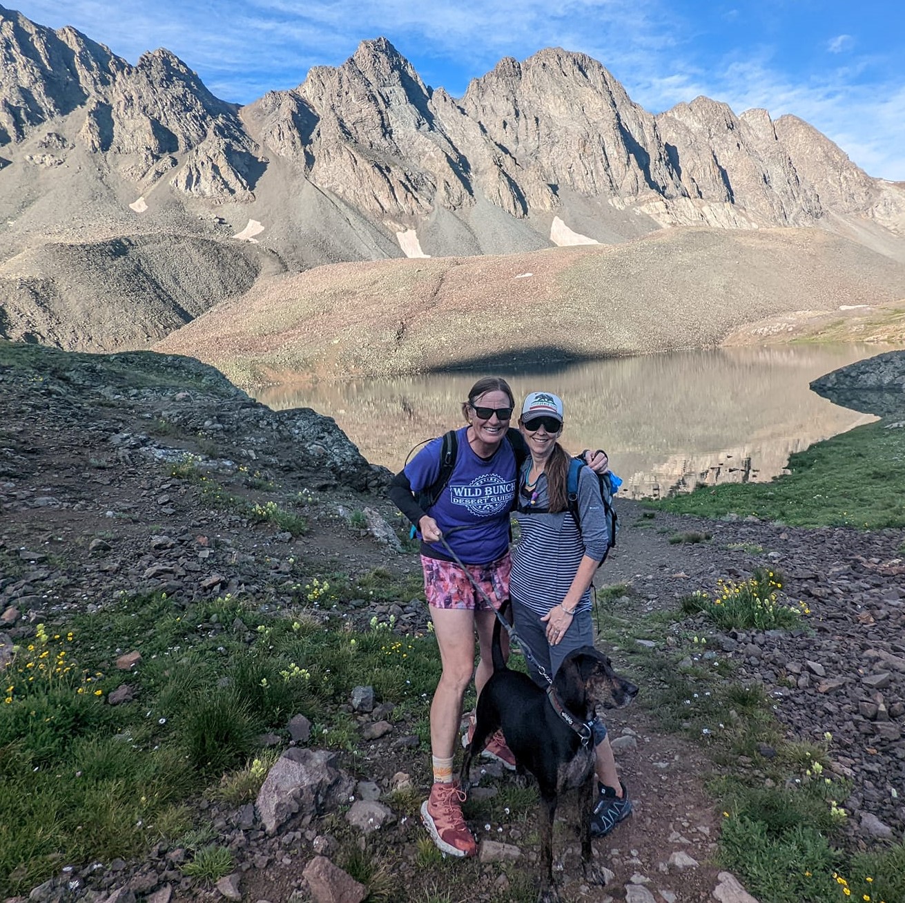 Laurel Darren, Lydia McNeese and Waylon the Plott Hound pose amid the breathtaking beauty of Handies Peak.