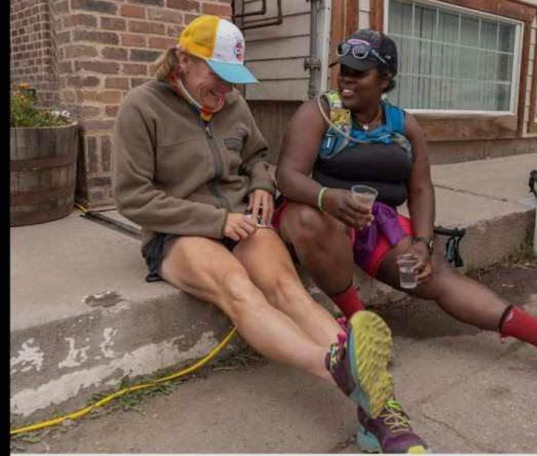 Laurel Darren (left) and The Mirnavator sit on some steps to laugh about their latest adventure together.