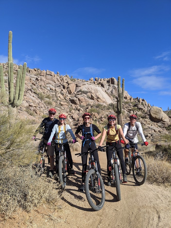 A group of mountain bike riders pause to enjoy the beautiful surroundings during a Wild Bunch tour.