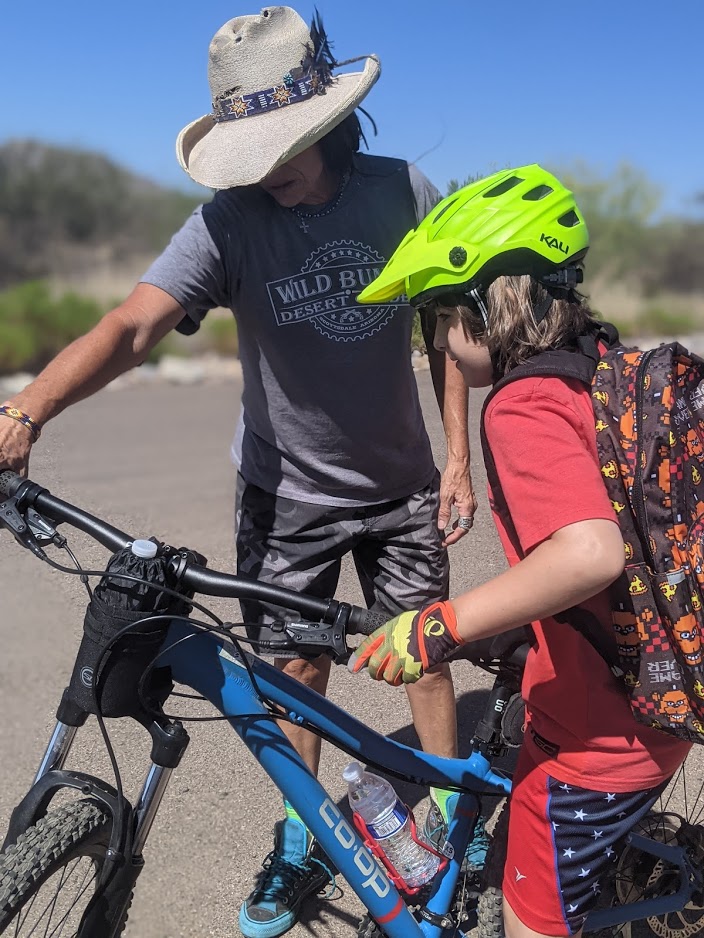 A Wild Bunch guide teaches a young, first-time mountain bike rider the basic fundamentals before a guided tour on the rocky trails of Scottsdale, Ariz.