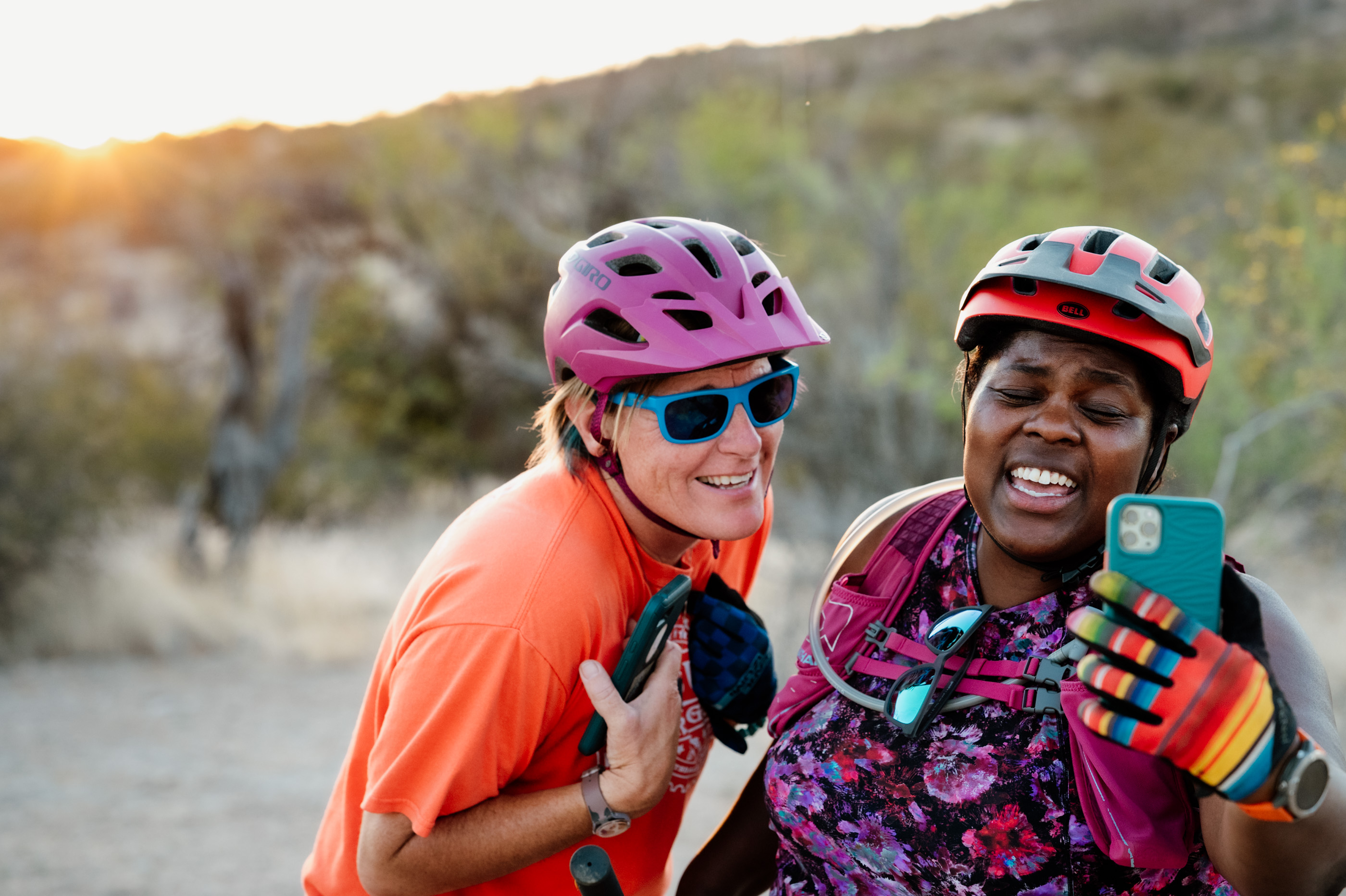 The Mirnavator (right) holds her cellphone up for a selfie picture while sharing a laugh with Laurel Darren during a Scottsdale mountain bike adventure.