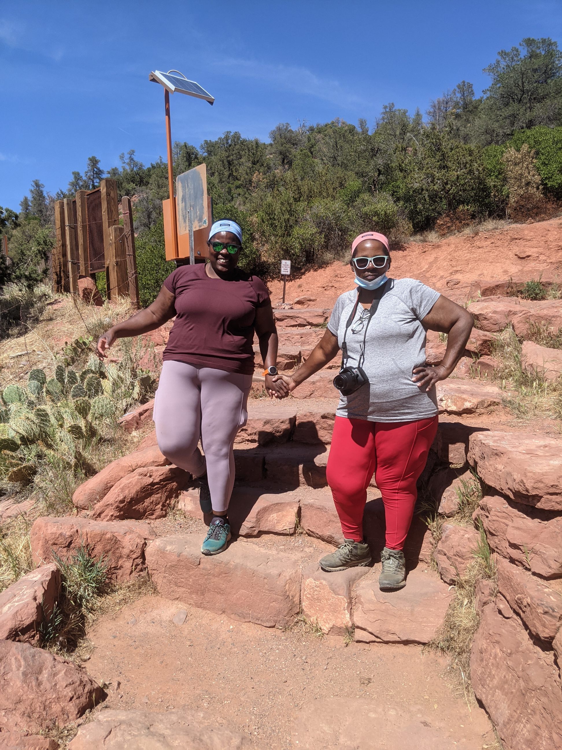 Mirna Valerio (left) and her mother JoAnn enjoy a moment together while holding hands on the Red Rocks of Sedona, Ariz. 