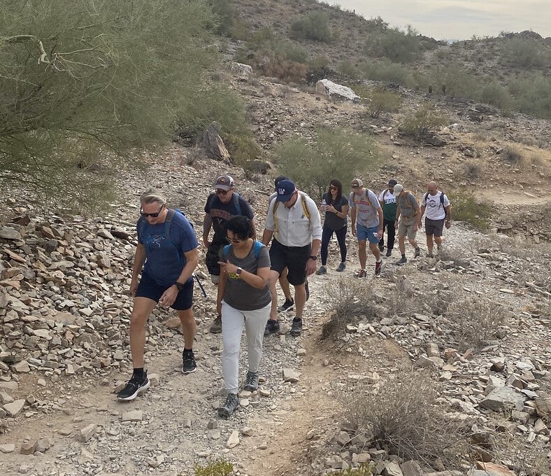 A Phoenix hiking group from Wild Bunch Desert Guides makes its way along a hillside trail.