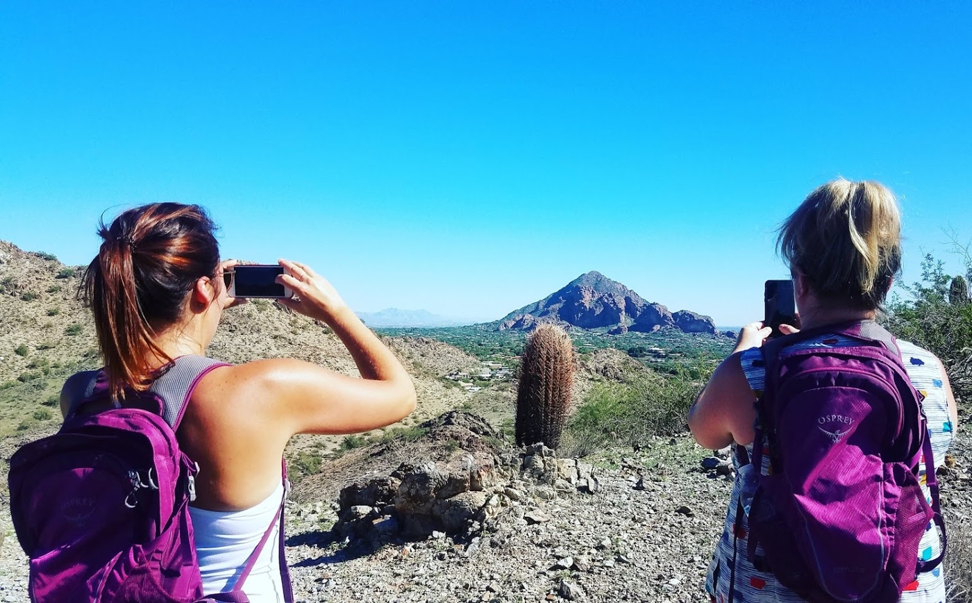 Two women take pictures of the breath-taking landscapes in Arizona's Sonoran Desert.