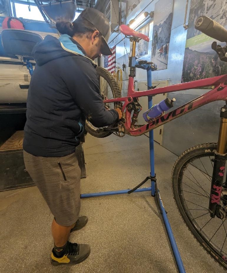 Reed Betz of Irwin Guides checks for maintenance issues on the bike of Wild Bunch Desert Guides owner Laurel Darren before their mountain bike adventure together in mid-September.