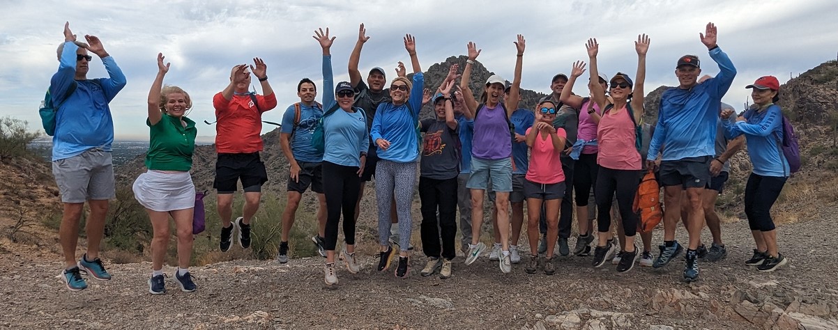 A Phoenix hiking tours group jumps for joy during their memorable Wild Bunch experience.