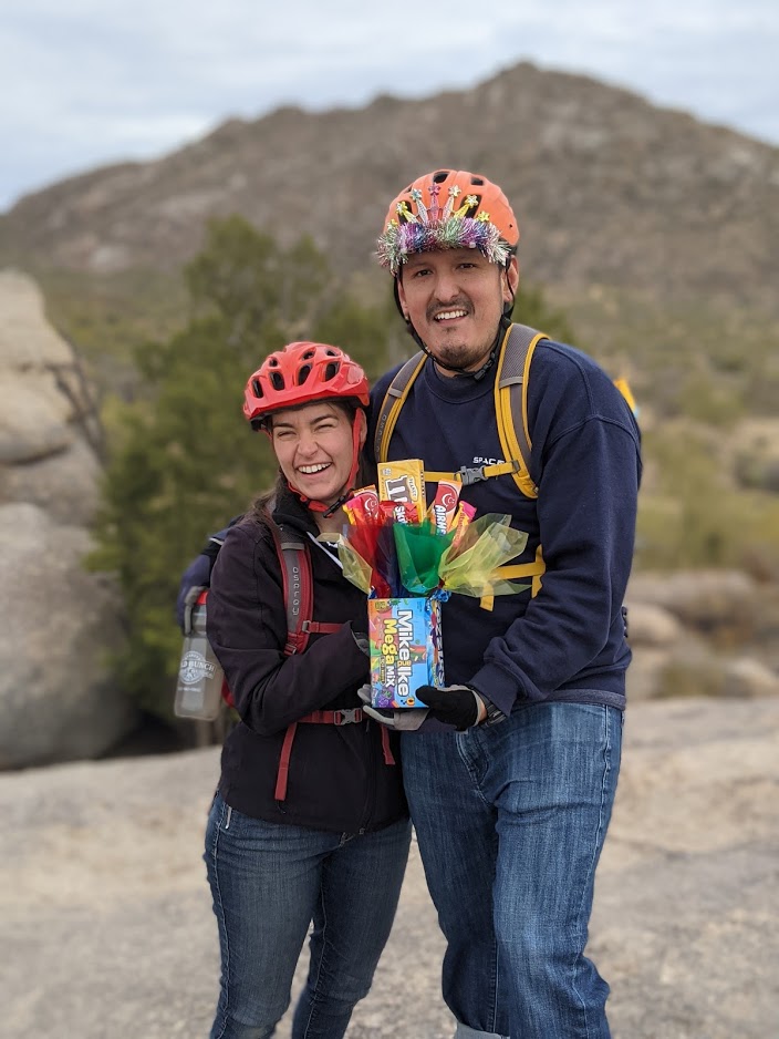 A married couple employed by the cutting-age company Space-X celebrates the husband's birthday with the present of candy on the Scottsdale hiking trails.