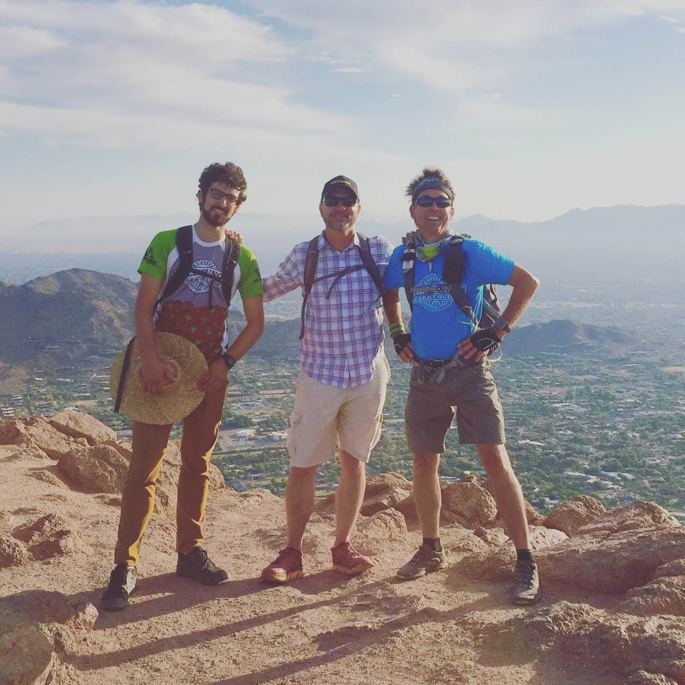 Three WIld Bunch Desert Guides enjoy the views from the summit during a Camelback Mountain hike.