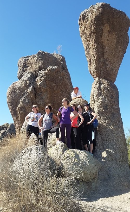 A group hike with the Wild Bunch takes a break for a photo together at the iconic Tom's Thumb rock formation,