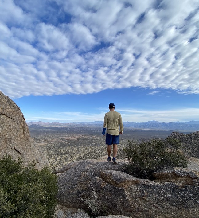 A guest admires the amazing views from Tom's Thumb during one of the Phoenix hiking tours from Wild Bunch Desert Guides..