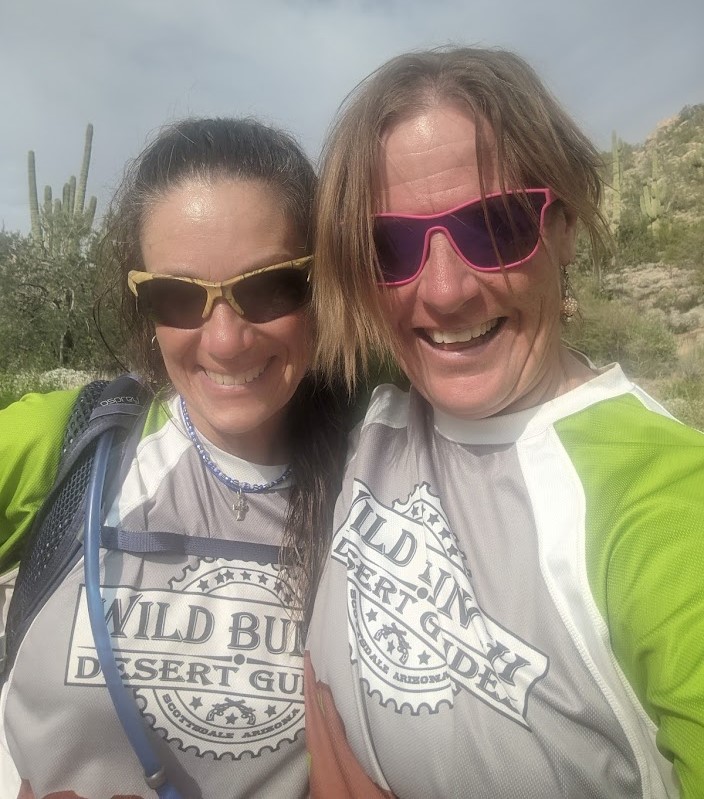Rebel (left) and Laurel Darren (right) are all smiles while enjoying a Wild Bunch Desert Guides hiking tour with a group of Veterans.