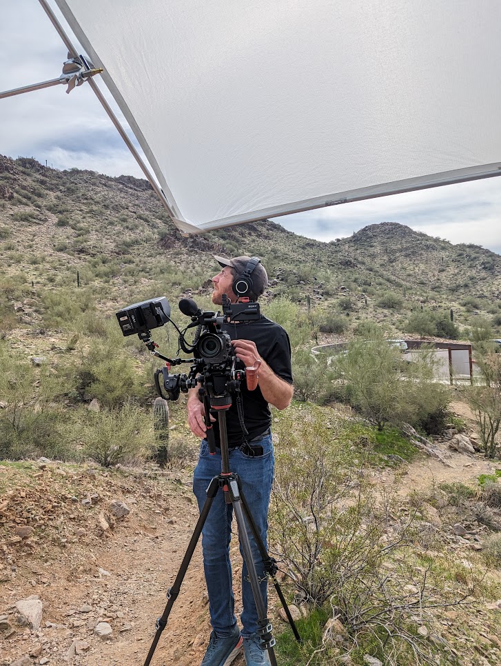 With a lighting screen hanging over head, a videographer for Visit Arizona does his work during a photo shoot with the Wild Bunch.