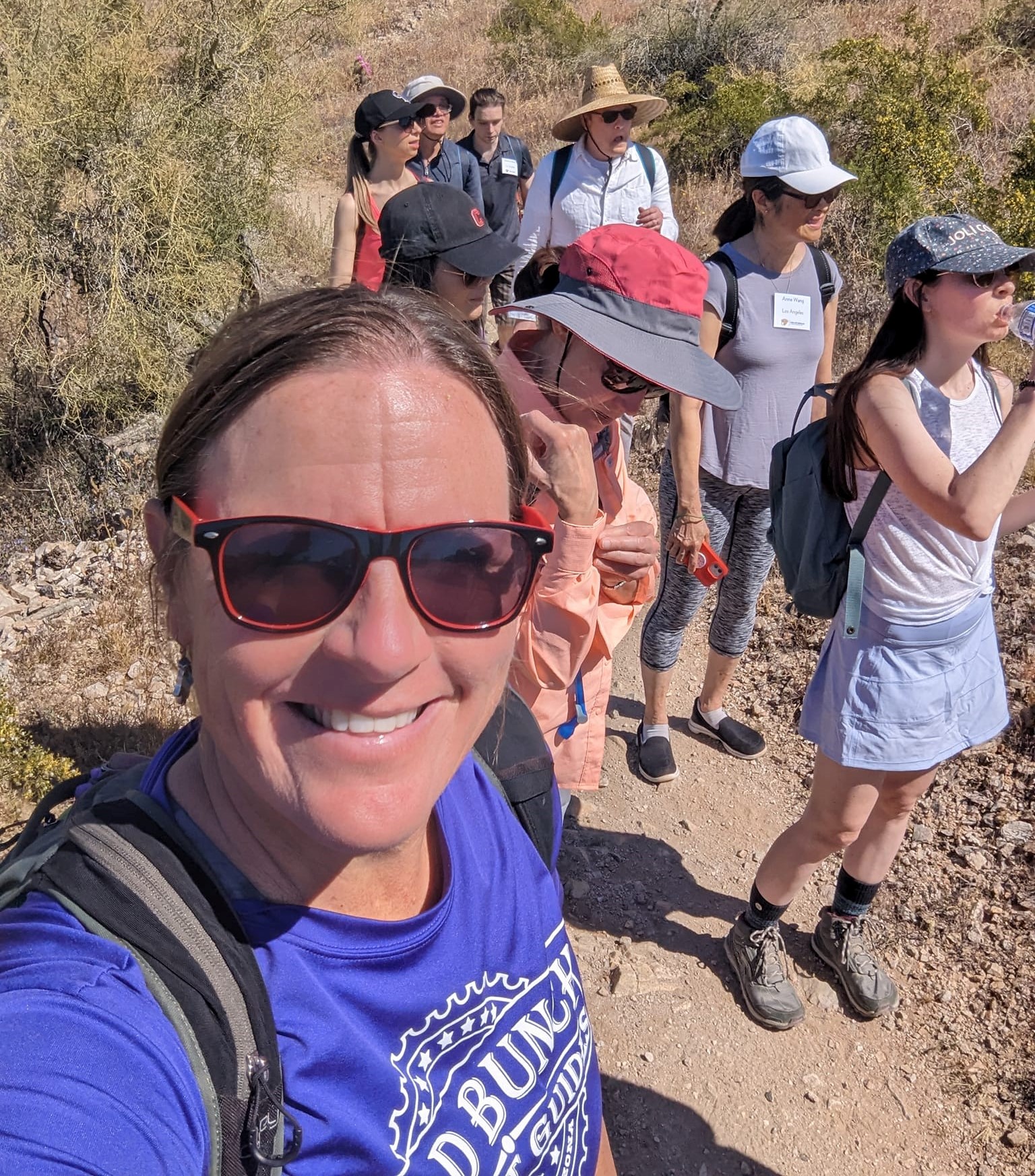 With guests in the background, Wild Bunch Desert Guides founder & owner Laurel Darren smiles proudly during another one of the successful Phoenix hiking tours from her boutique business.